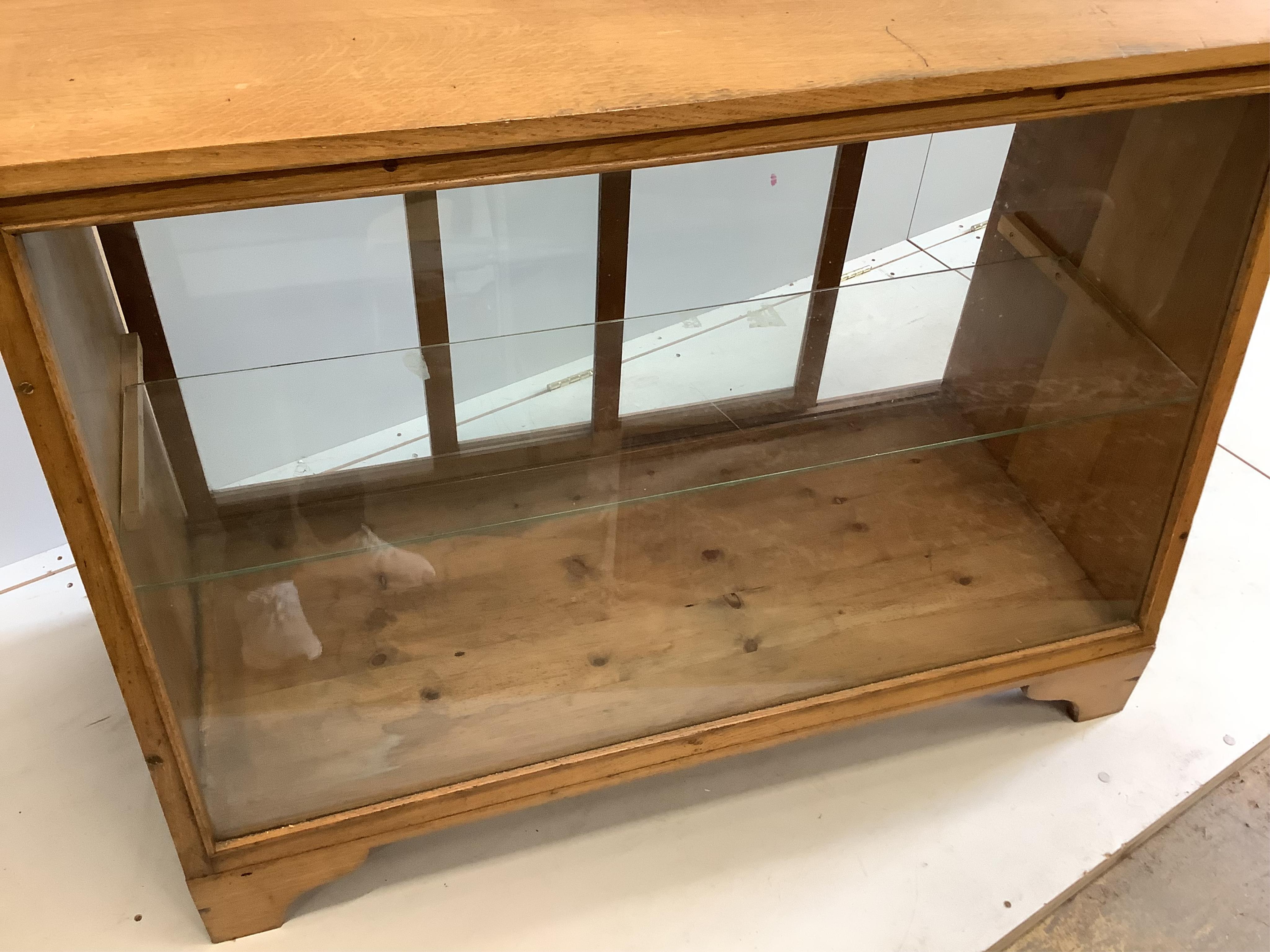A mid century glazed oak haberdasher's cabinet, width 124cm, depth 56cm, height 90cm. Condition - fair